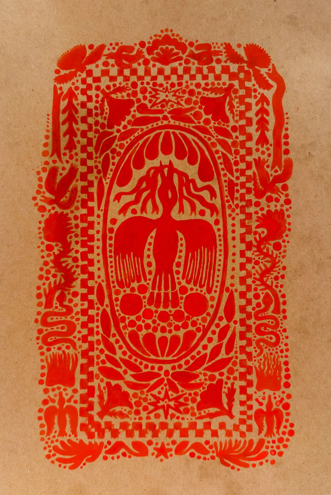 Red folk-art print on toned paper: a bird with outstretched wings inside an oval medallion, framed by borders of checkerboard, dots, leaves and flowers.