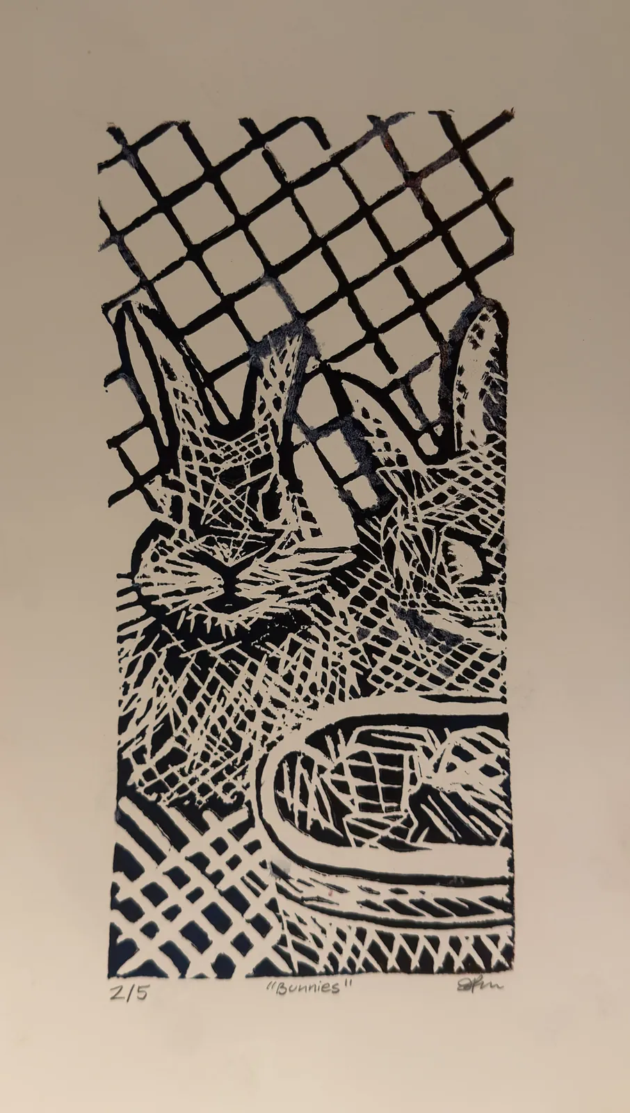 Black relief print of two rabbits sitting behind a lattice fence, their fur built from dense carved hatching.
